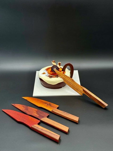 Wood cake knives displayed on cake handmade in San Diego by Mostad Works