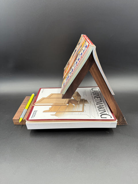 Angled view of hardwood book holder with books made by Mostad Works San Diego