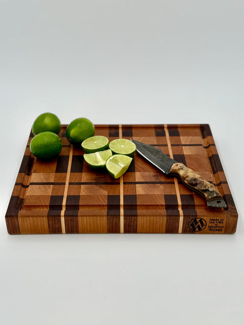 Plaid cutting board in use with limes and knife handcrafted in San Diego by Mostad Works