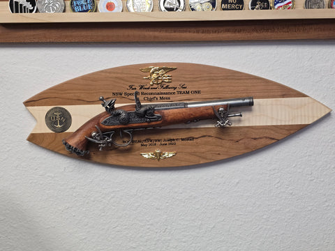 Custom made surfboard with flintlock plaque as a going away gift, handcrafted by Mostad Works
