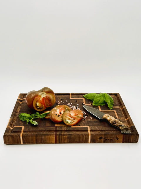 Staircase cutting board in use with vegetables and knife handcrafted in San Diego